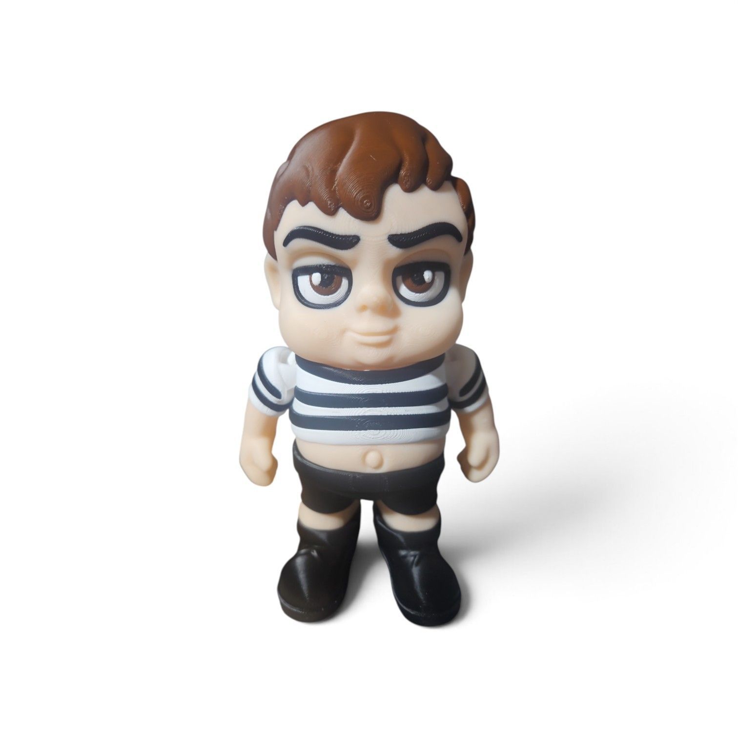 Small toy figure with brown hair, striped shirt, and black boots on a white background