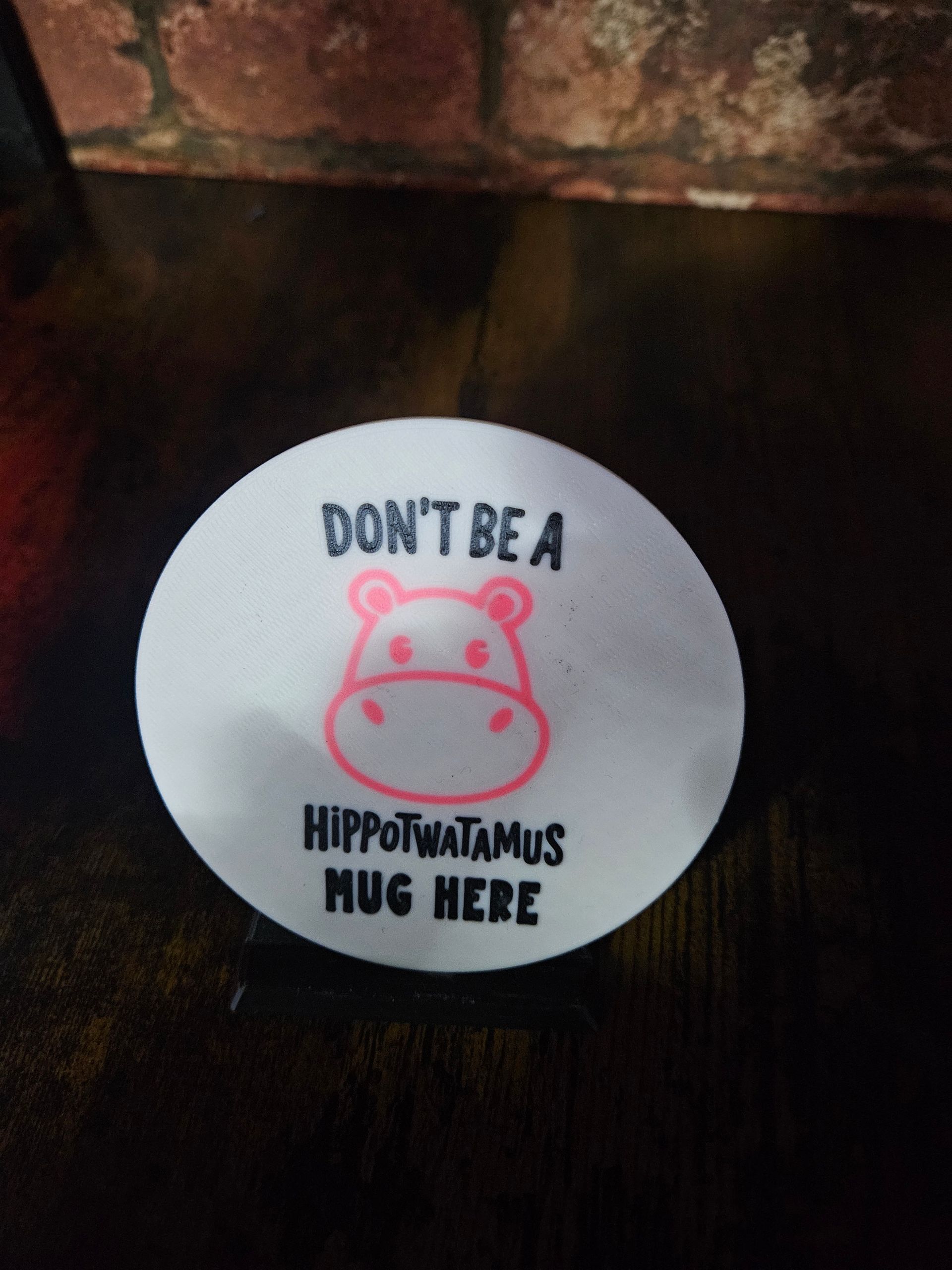 White circle with pink hippo and text: