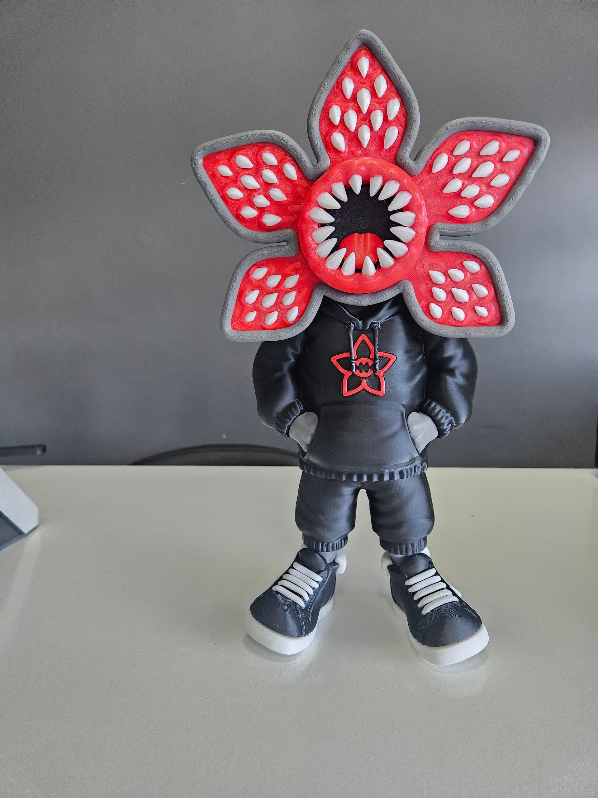 Demogorgon action figure wearing a black hoodie and sneakers.