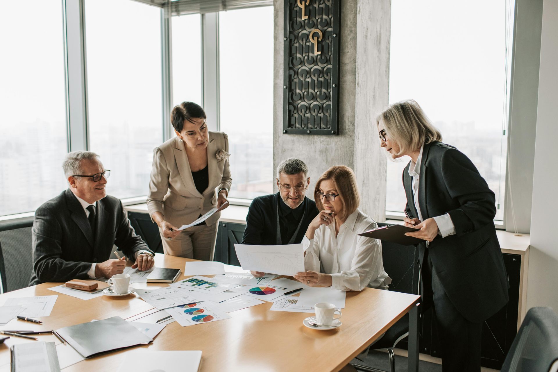 Business team reviewing documents at a table in an office.