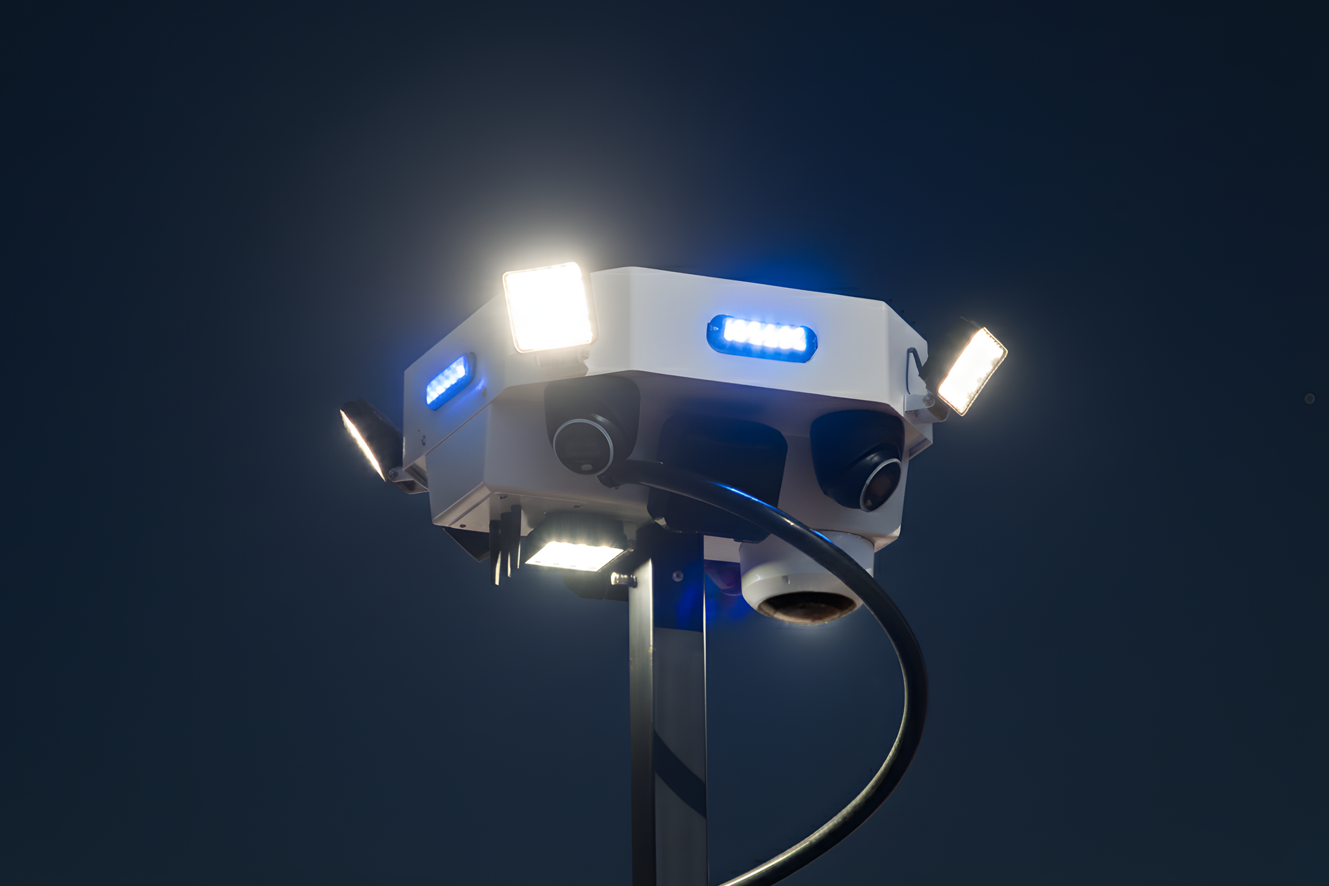 photorealistic mobile surveillance tower with blue strobe lights active at night