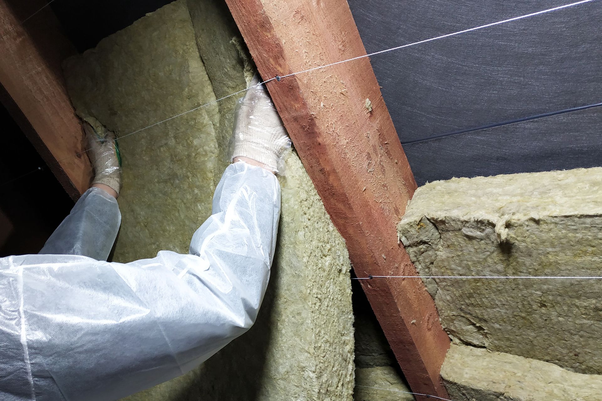 A person is holding a piece of rock wool in their hands.
