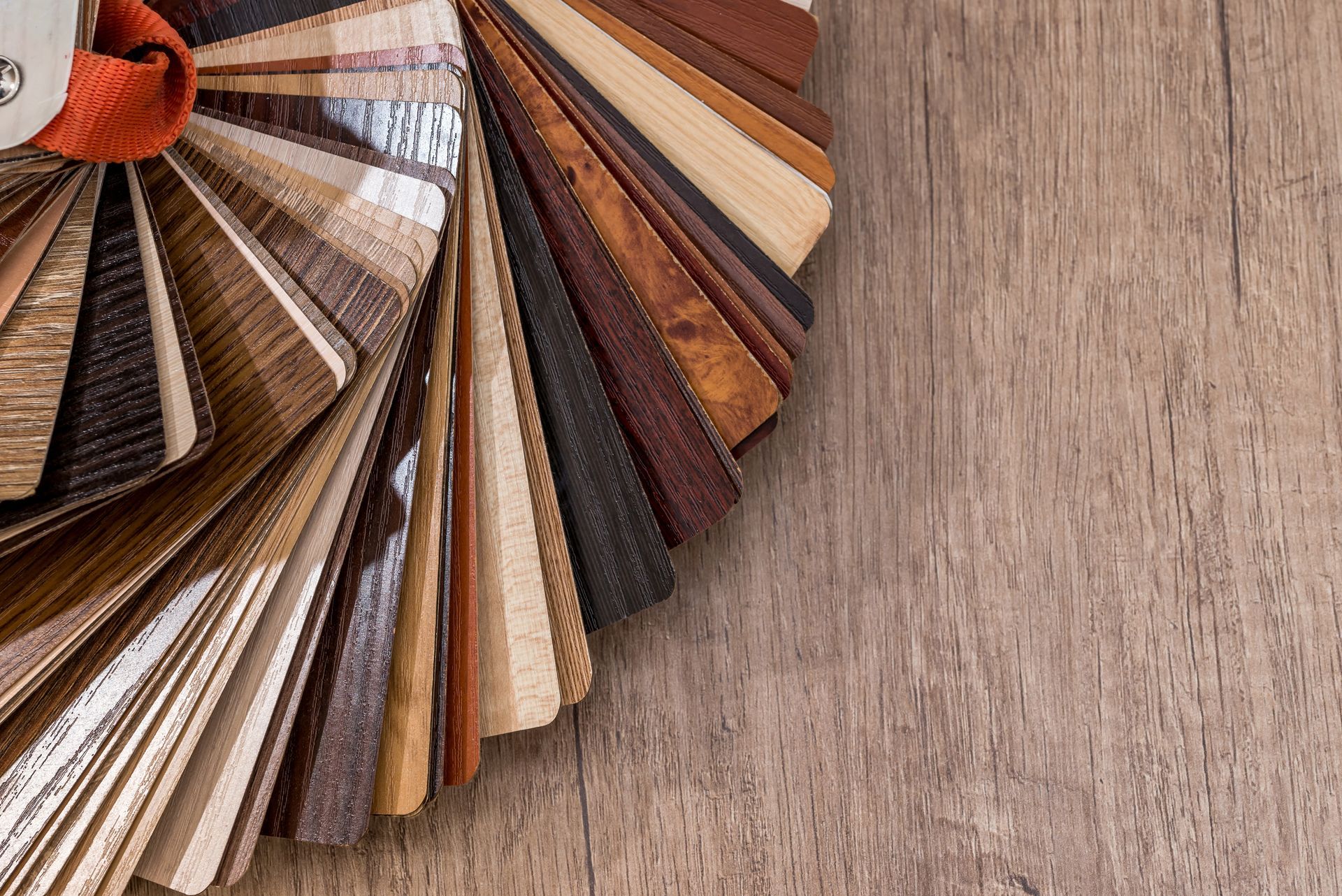 Fan of fabric and wood color swatches on a textured surface