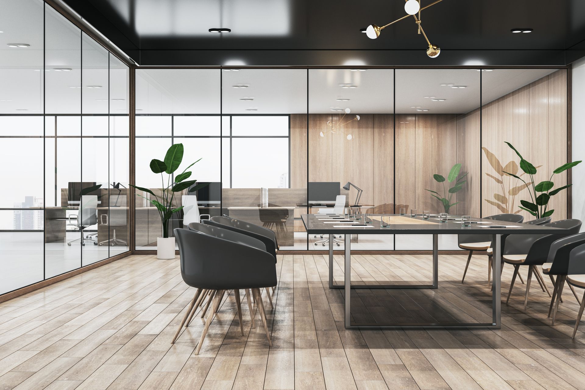 Modern open-plan office with glass walls, black chairs, wood floors, and a large meeting table