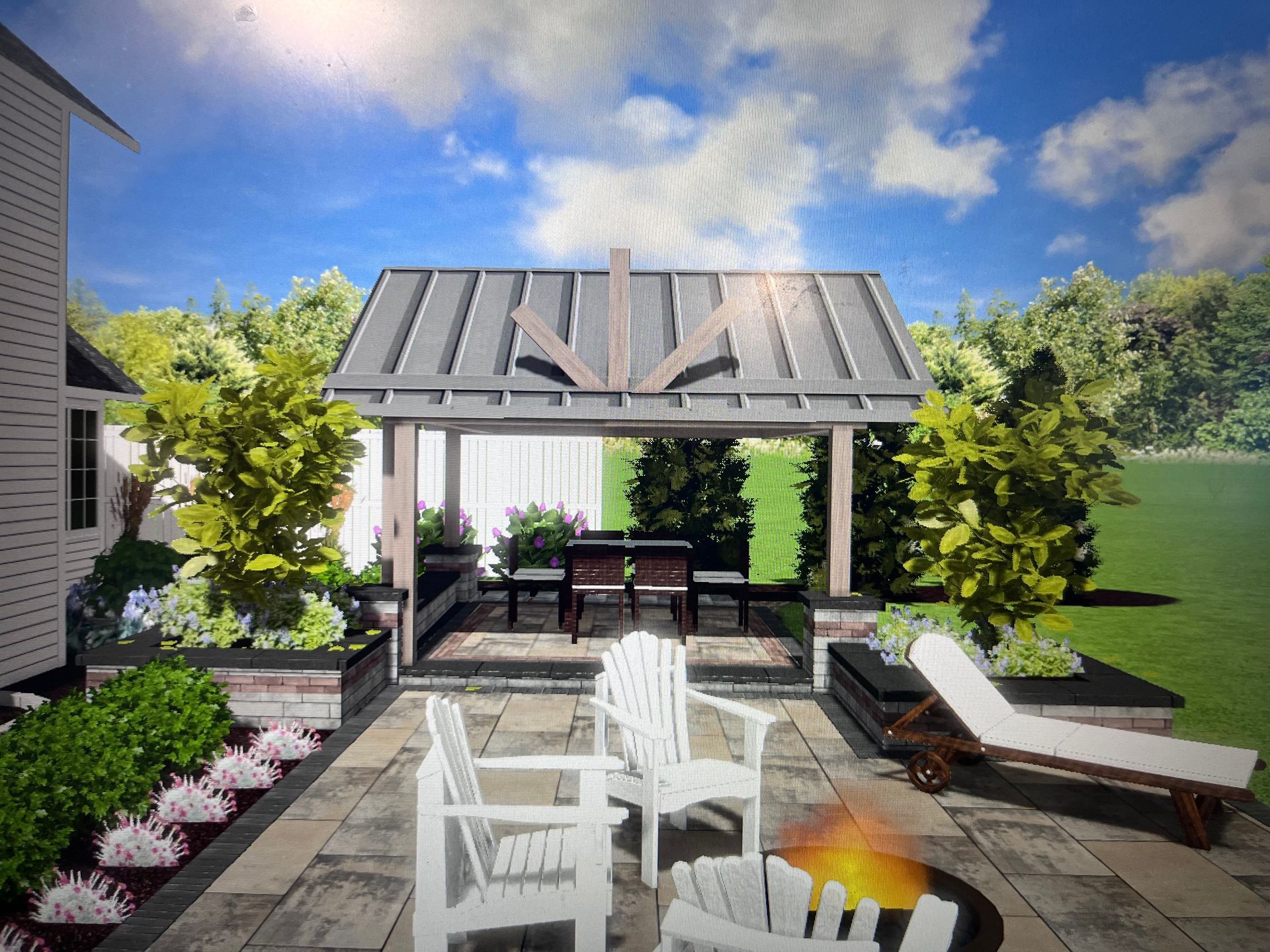 Patio with fire pit, pergola, white chairs, and lounge chair; lush greenery and blue sky.