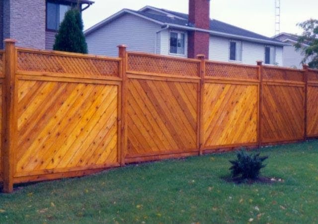 A wooden fence with a house in the background
