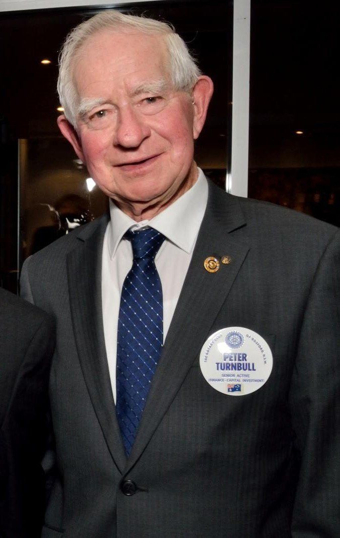 A man in a suit and tie with a name tag that says ' thomas ' on it