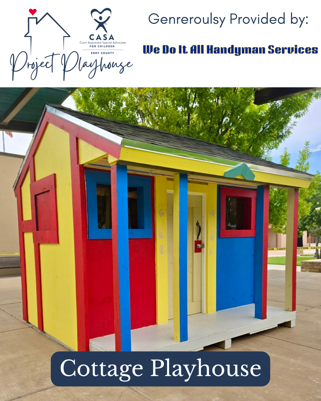 Colorful cottage playhouse with red, blue, yellow, and white walls and a gray roof