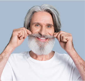 A man with a beard is holding his mustache in front of his face.