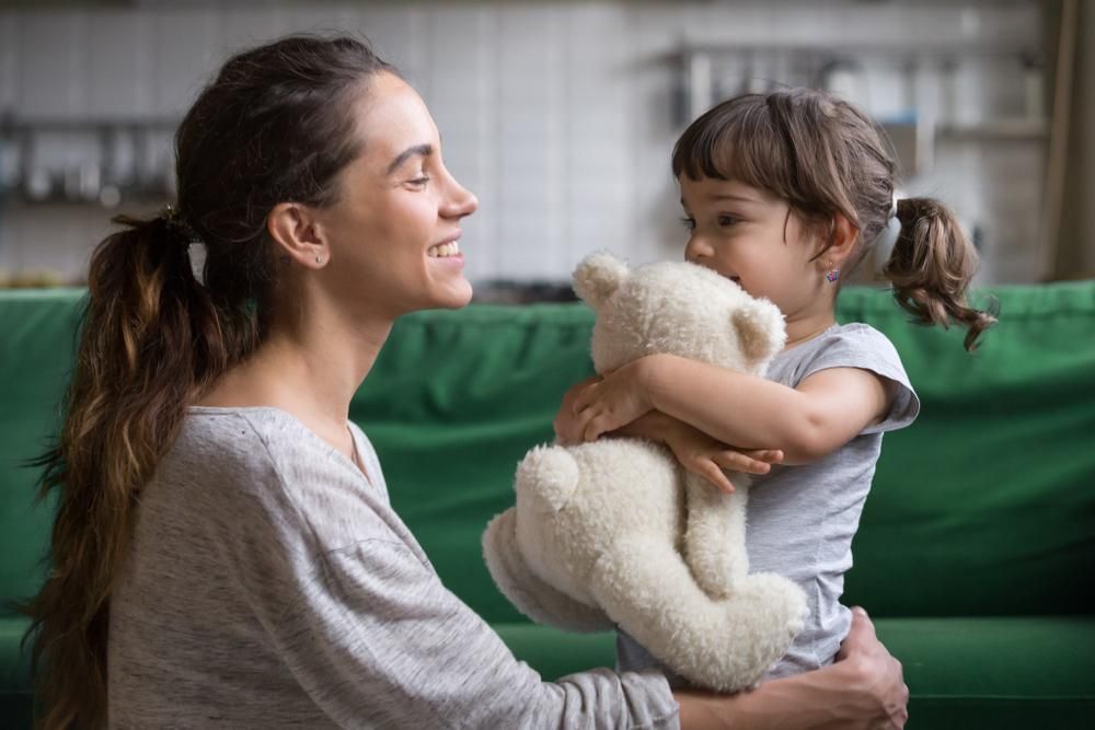 Counselor Speaking with A Seated Child in A Office, Holding a Clipboard and Pen — Active Ables Community Services In Brookwater, QLD