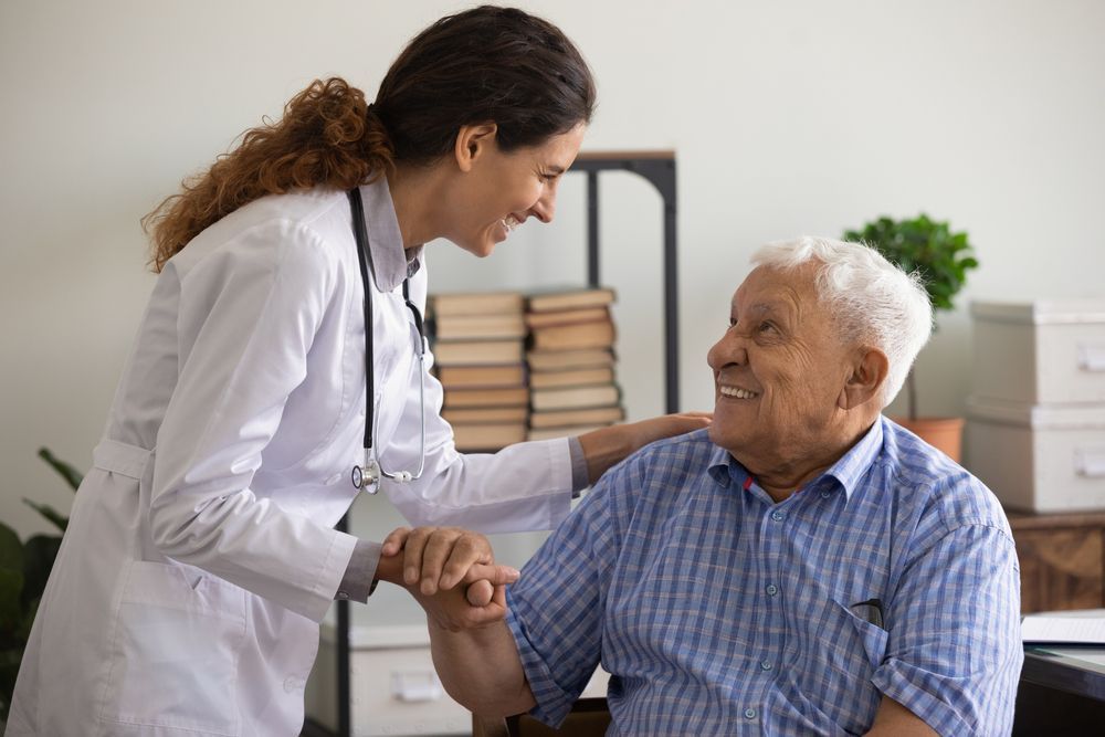 A Doctor Is Holding The Hand Of An Elderly Man — Active Ables Community Services In Tamworth, NSW