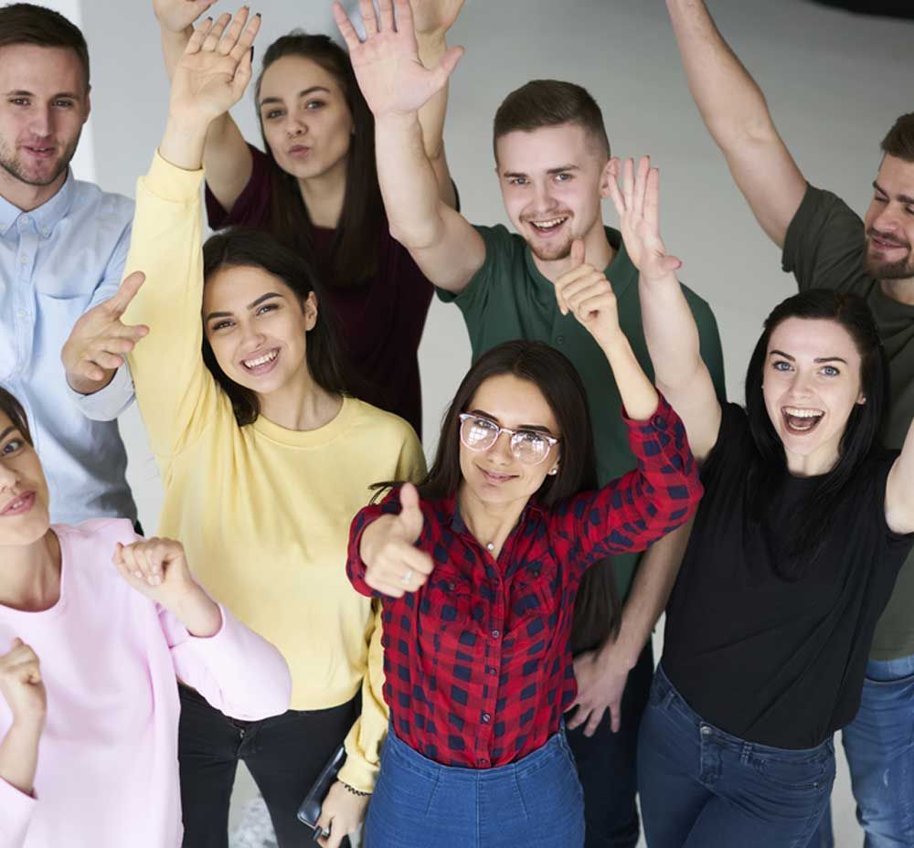 A Group of People Are Posing for A Picture with Their Hands in The Air — Active Ables Community Services In Toowoomba, QLD