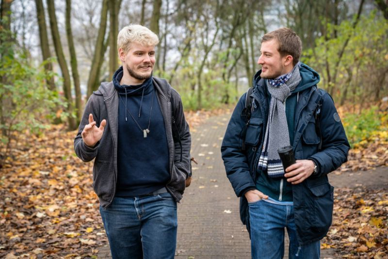 Two Men Are Walking Down a Path in The Woods — Active Ables Community Services In Tamworth, NSW