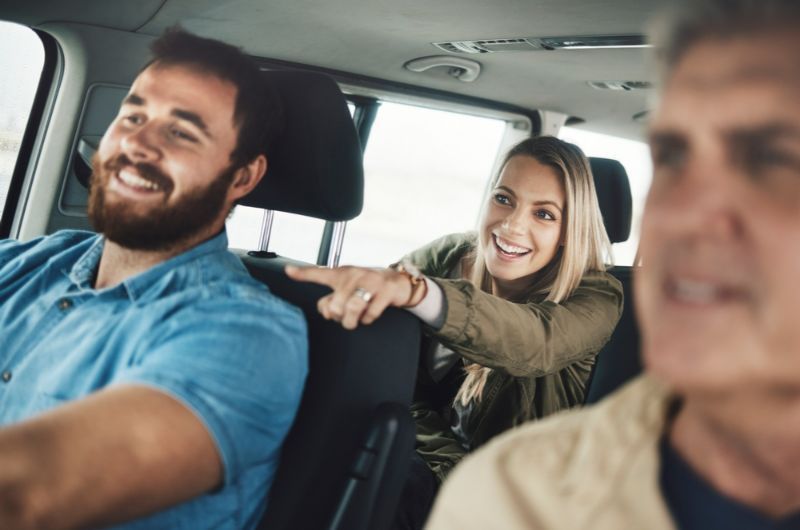 A Man and A Woman Are Sitting in The Back Seat of A Car — Active Ables Community Services In Tamworth, NSW