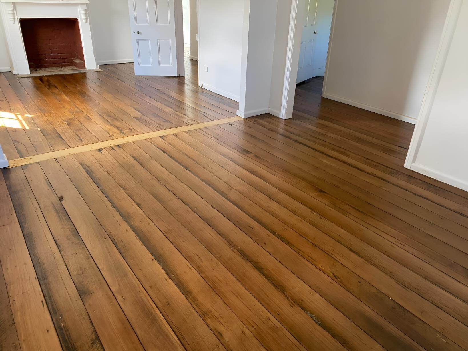 A Living Room With Hardwood Floors And A Fireplace โ Coolangatta Floor Sanding In Shoalhaven Heads, NSW