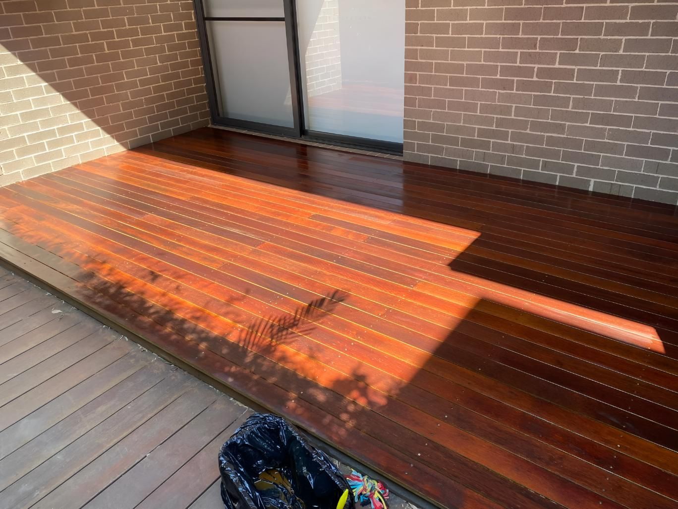A Wooden Deck Is Sitting In Front Of A Brick Building โ Coolangatta Floor Sanding In Shoalhaven Heads, NSW