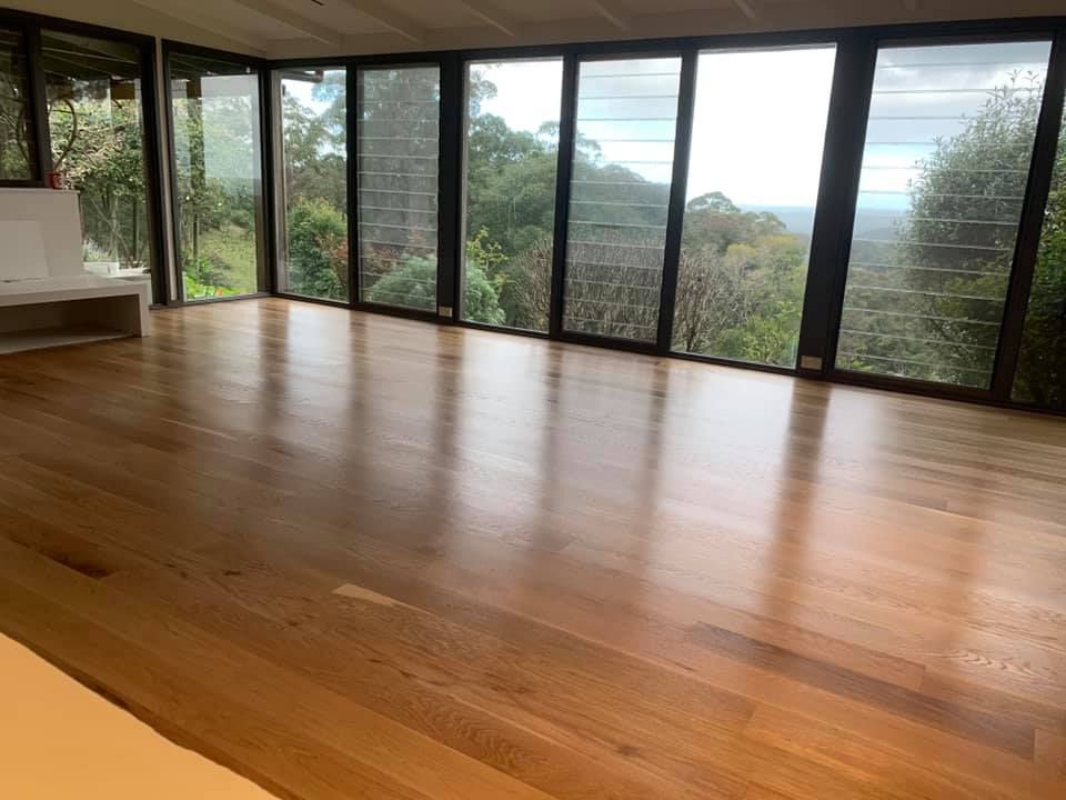 A large empty room with hardwood floors and lots of windows โ Coolangatta Floor Sanding In Shoalhaven Heads, NSW