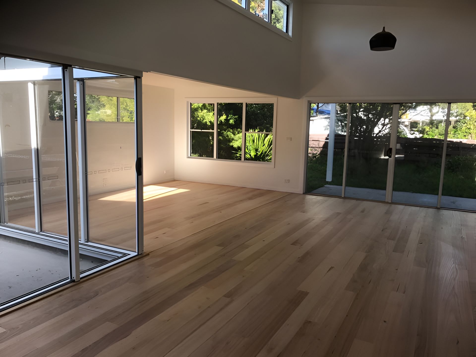 A Large Empty Room With Lots Of Windows And Wooden Floors โ Coolangatta Floor Sanding In Shoalhaven Heads, NSW
