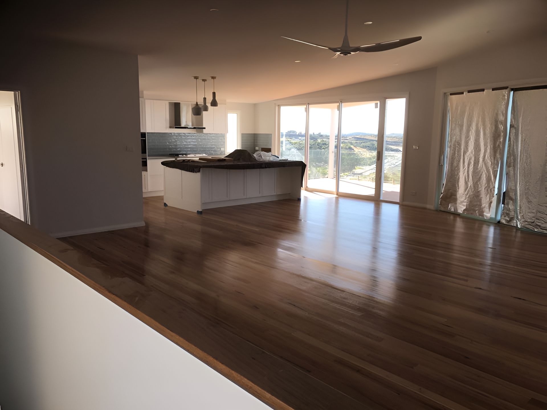 An Empty Room With Hardwood Floors And A Ceiling Fan โ Coolangatta Floor Sanding In Shoalhaven Heads, NSW