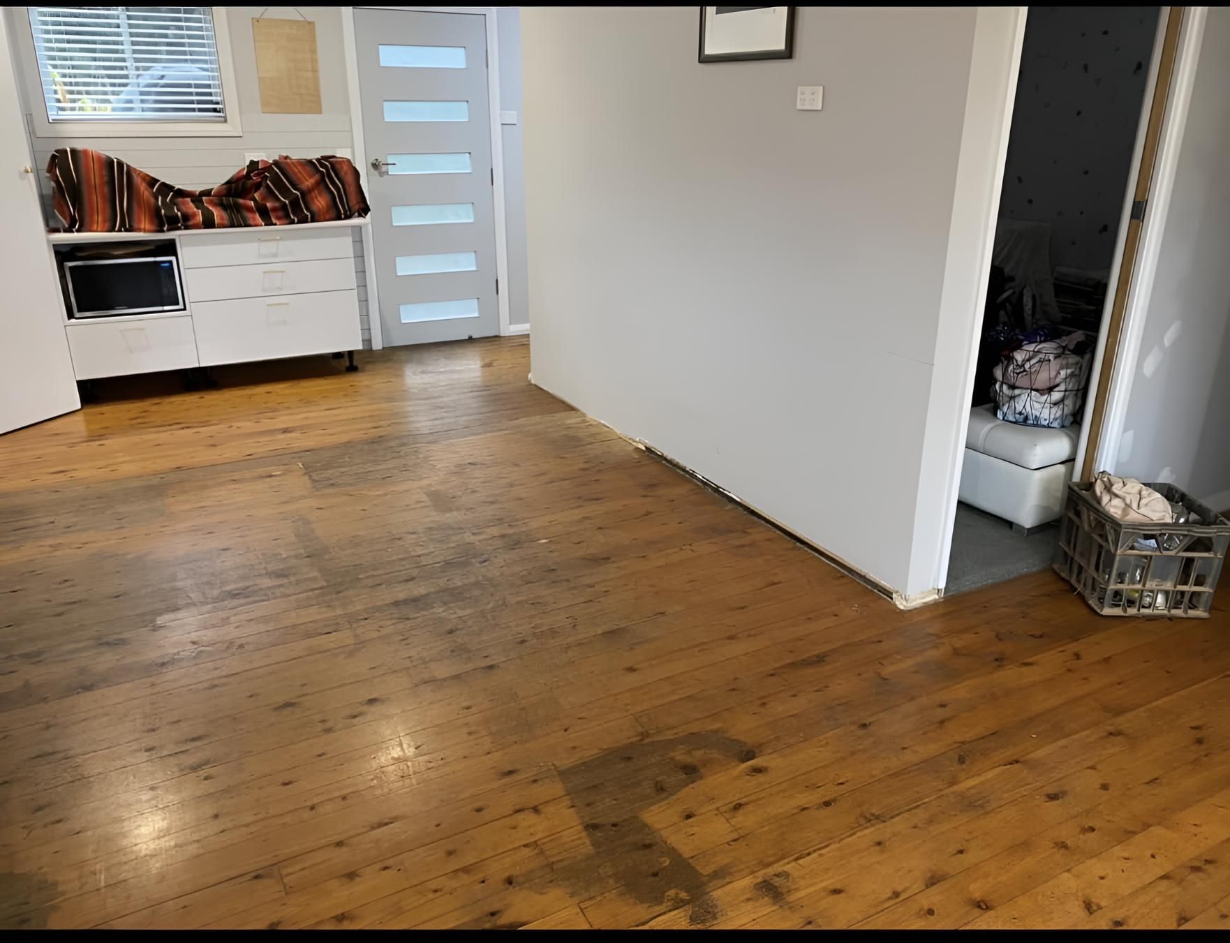 A Living Room With A Wooden Floor And A Basket On The Floor โ Coolangatta Floor Sanding In Shoalhaven Heads, NSW