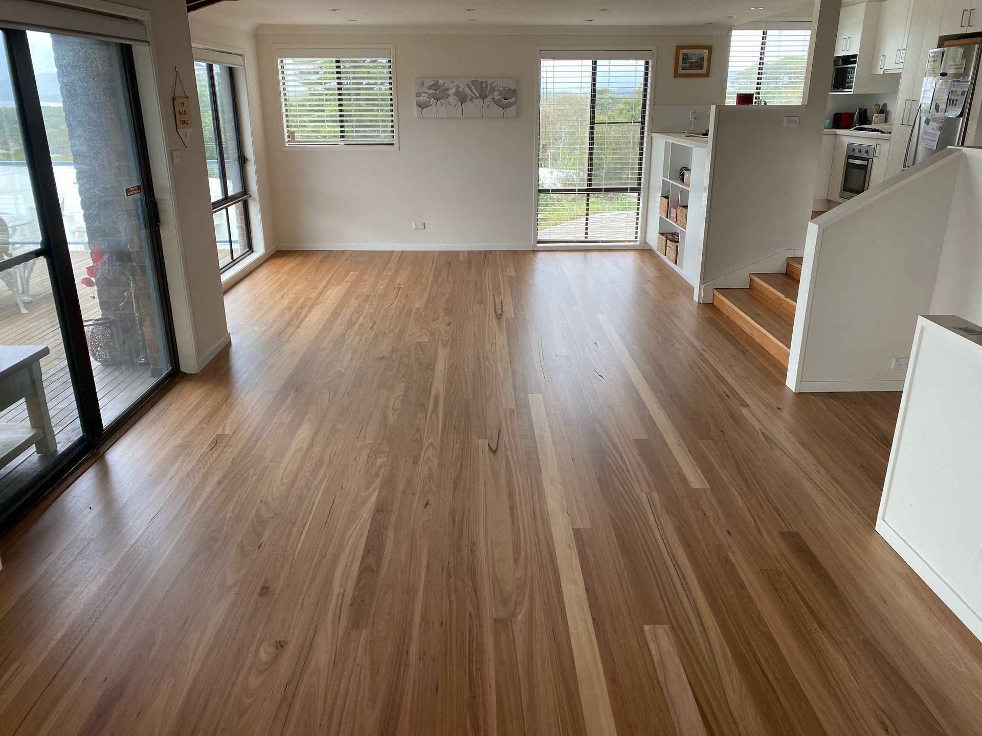 A living room with hardwood floors and stairs โ Coolangatta Floor Sanding In Shoalhaven Heads, NSW
