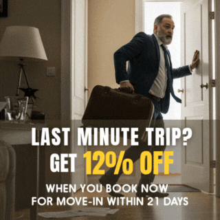 A man in a suit and tie is carrying a suitcase and a sign that says last minute trip get 12 % off