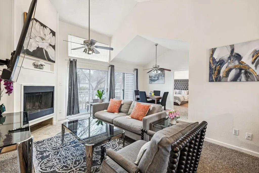A living room filled with furniture and a fireplace.