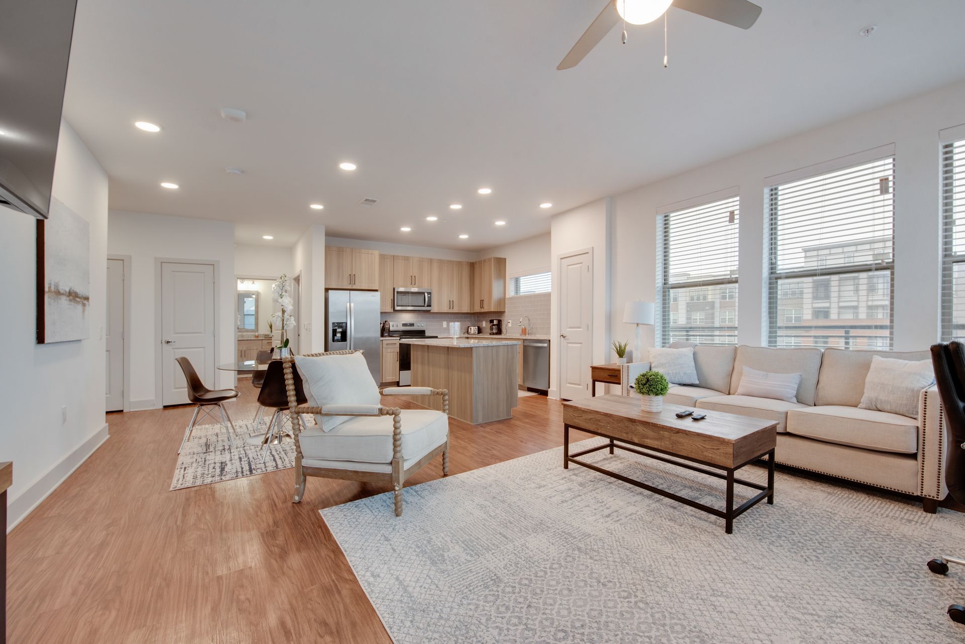 A living room filled with furniture and a ceiling fan.