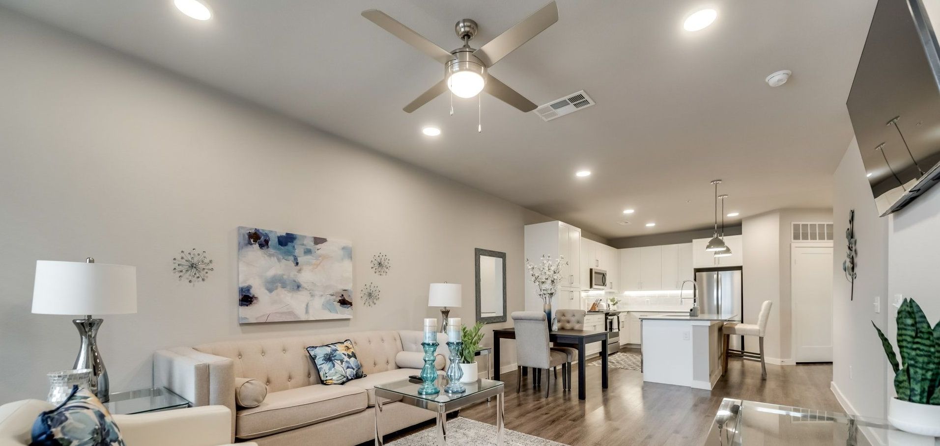 A living room with a ceiling fan and a couch.