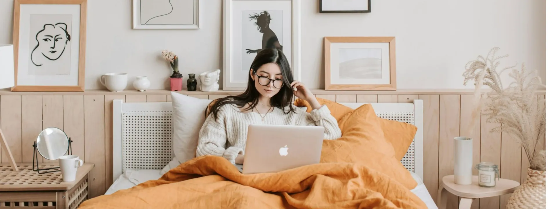 A woman is sitting in a rocking chair in a bedroom.