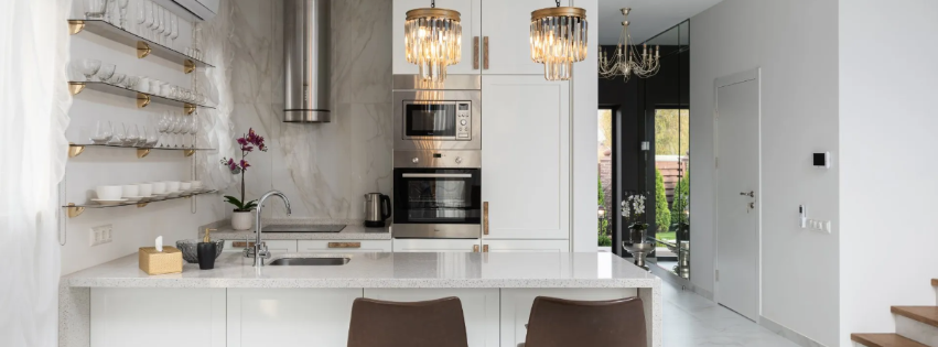 A modern kitchen with white cabinets and stainless steel appliances.