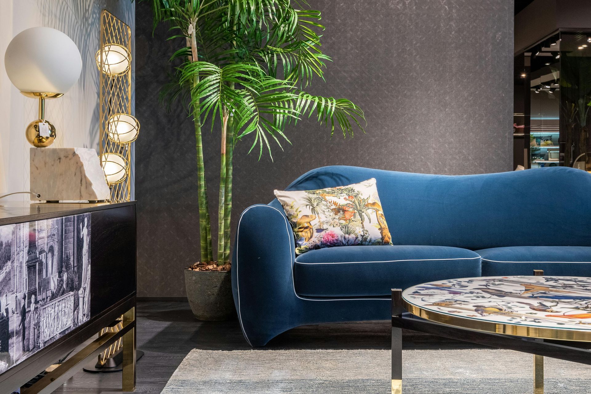 A living room with a blue couch and a coffee table