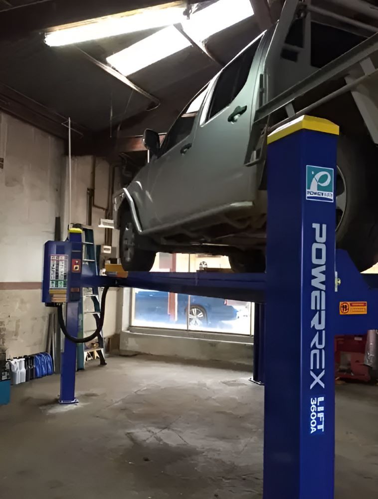 A Car is Sitting on a Power Rex Lift in a Garage — Mayne Street Auto in Gulgong, NSW