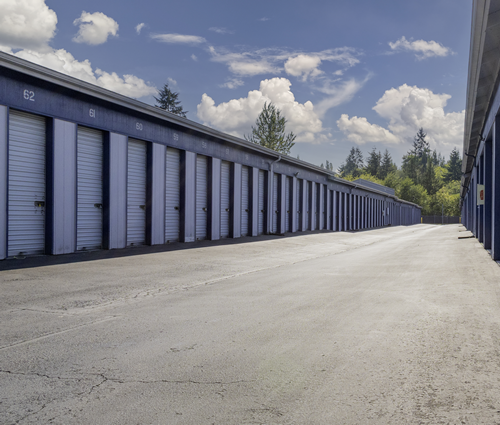 Row of clean drive up storage units at Everett Mall Mini Storage in Everett WA with wide access lanes