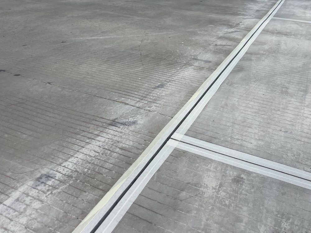 Concrete pavement with expansion joints and light gray surface markings