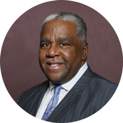 A man in a suit and tie is smiling in a circle