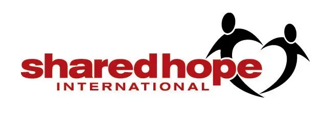 A logo for shared hope international with two people holding hands and a heart.