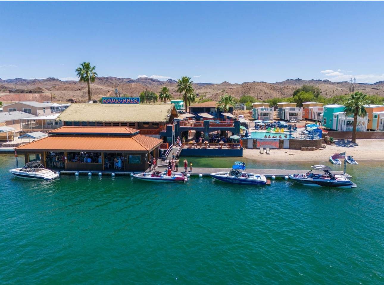 An aerial view of a marina with boats docked in the water.