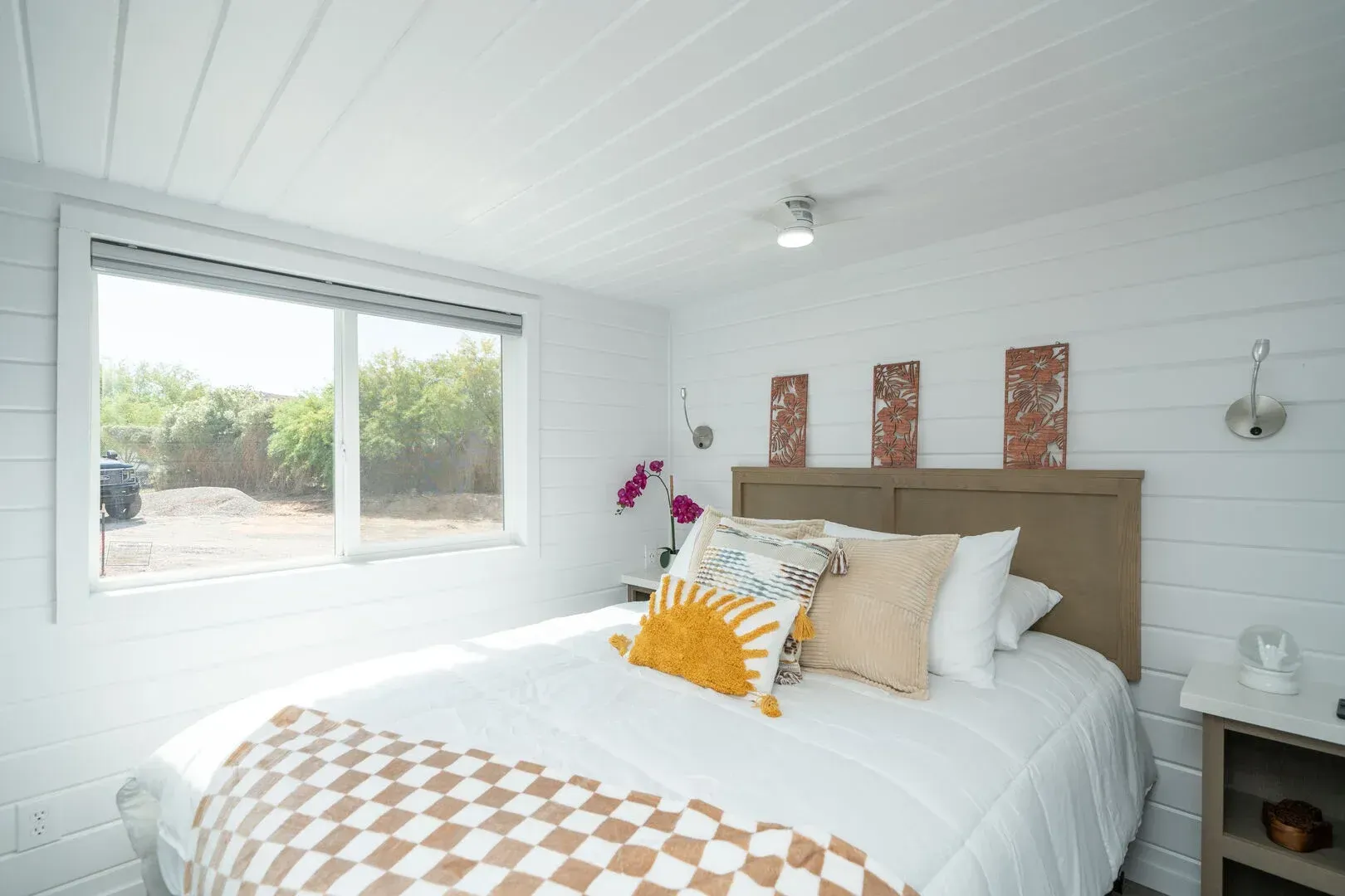 A bedroom with a large bed and a window.
