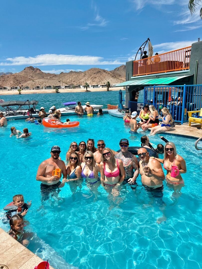 A group of people are standing in a swimming pool.