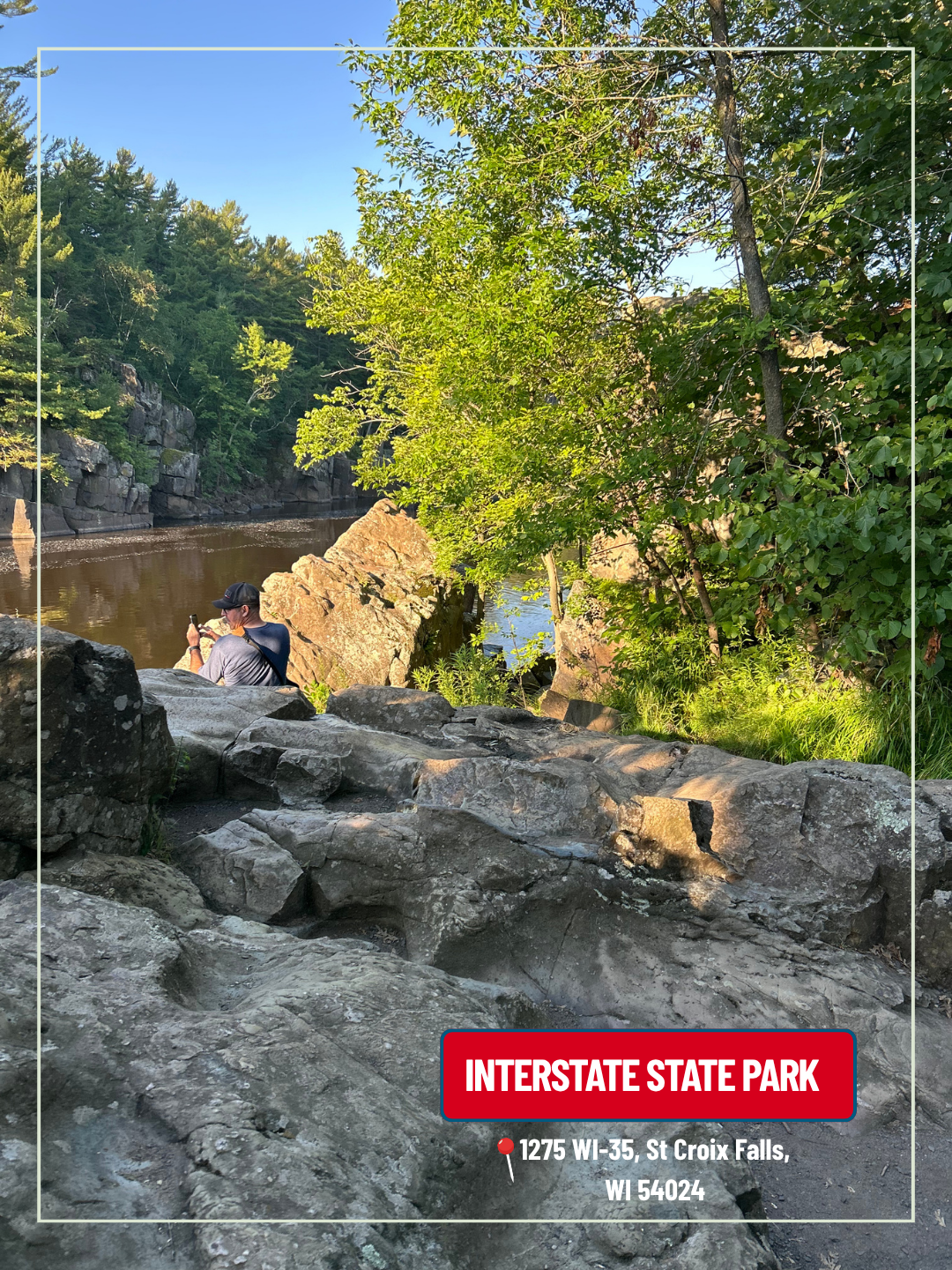 Rocky stream in sunlit Interstate State Park with trees and a small waterfall under blue sky