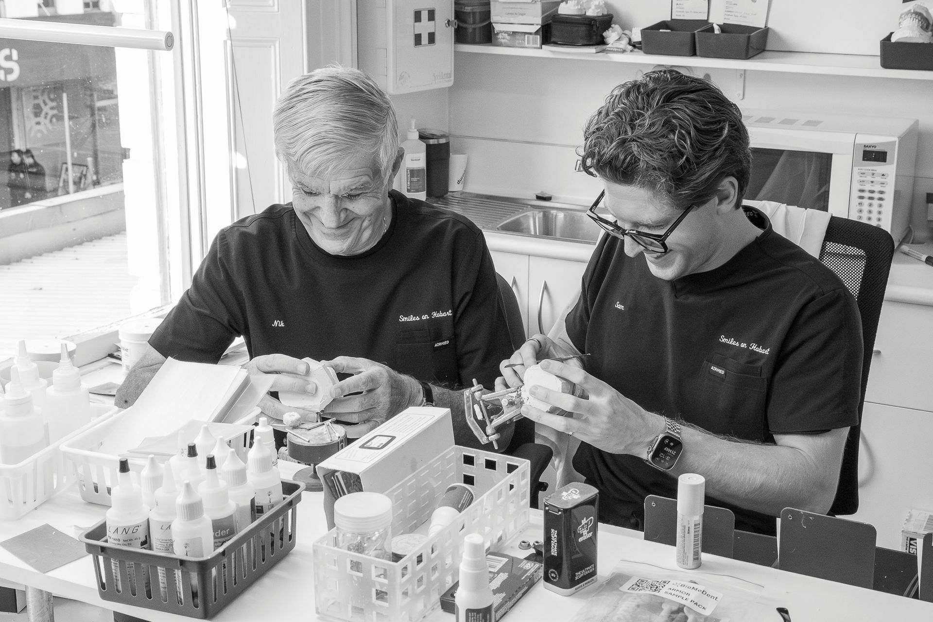 Two People in a Lab Bench Setting Examining Small Samples — Smiles On Hobart in Hobart, TAS