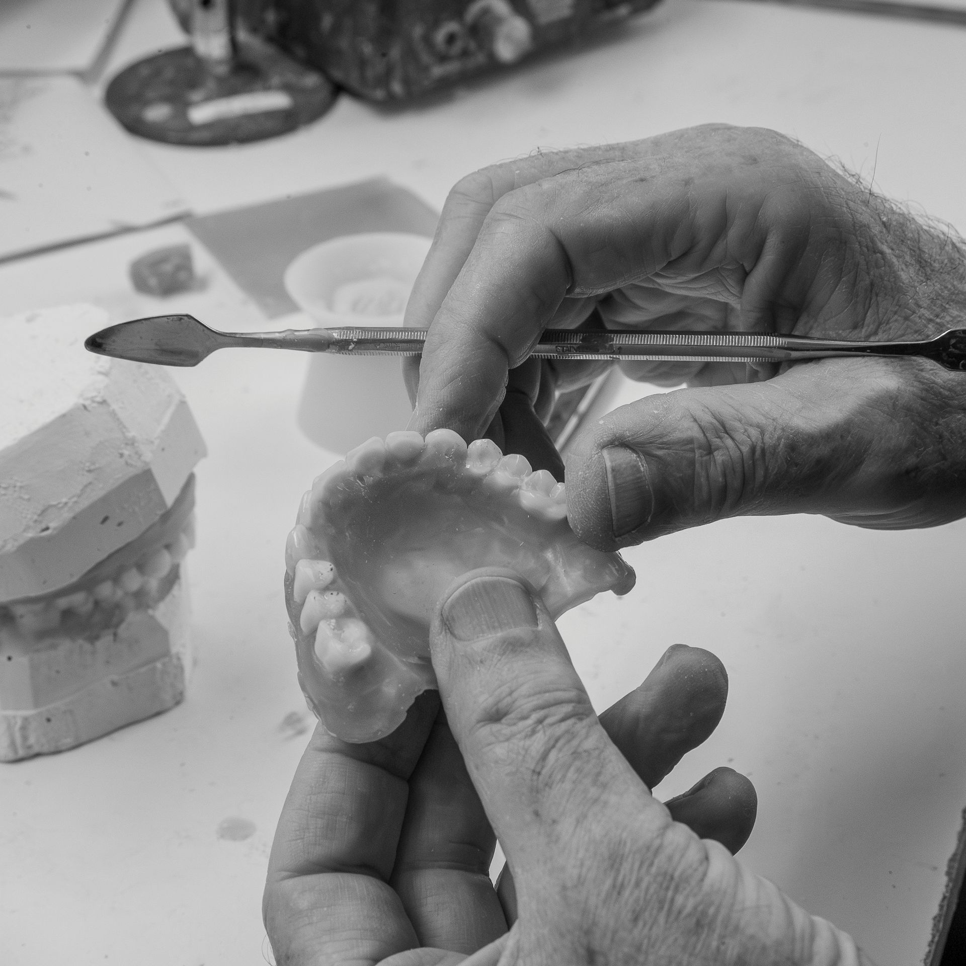 Hands Sculpting a Small Clay Tooth — Smiles On Hobart in Hobart, TAS