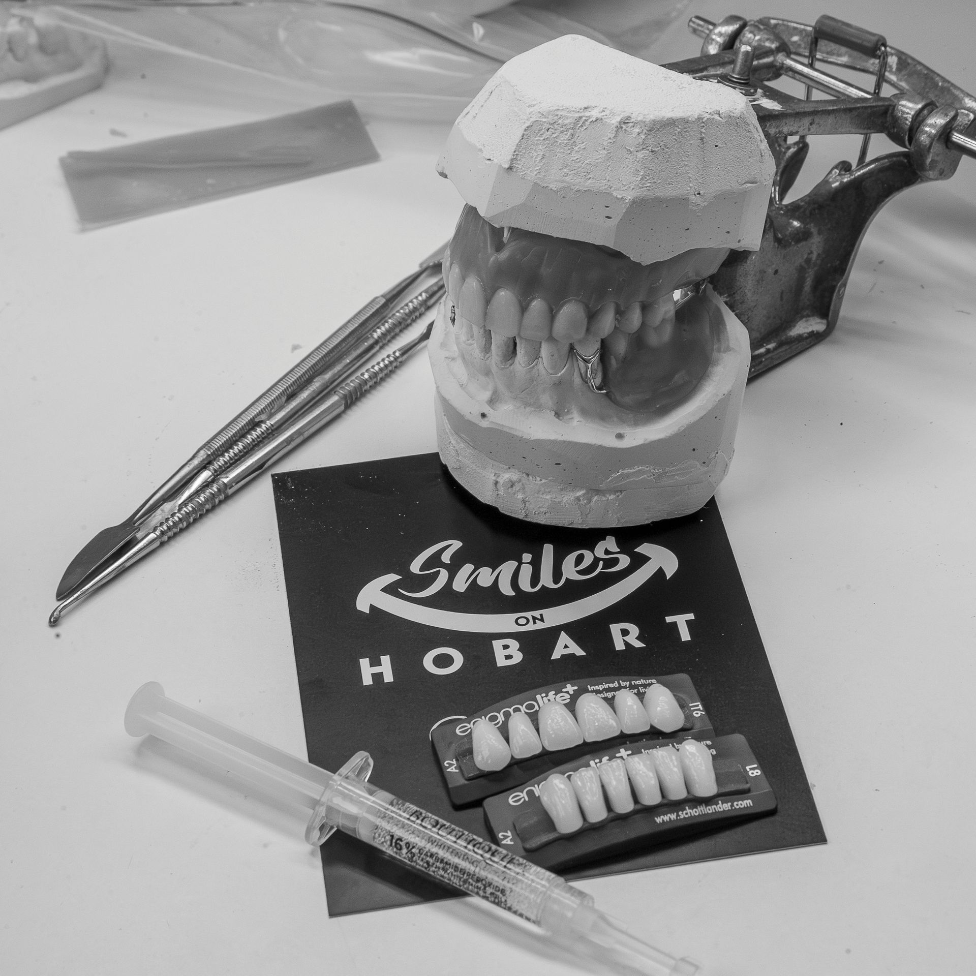 Dental Model on a Desk Beside a Syringe — Smiles On Hobart in Hobart, TAS