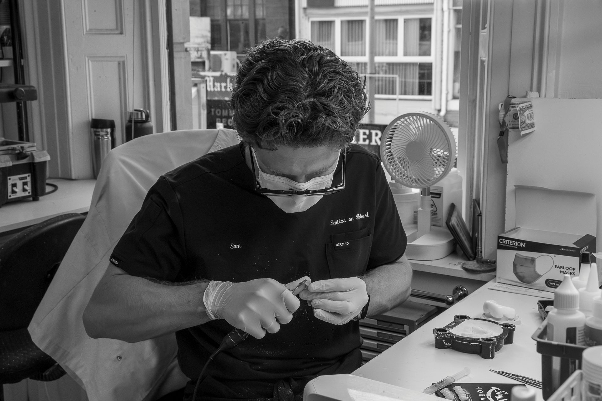 Person Working Intently at a Desk in a Workshop — Smiles On Hobart in Hobart, TAS