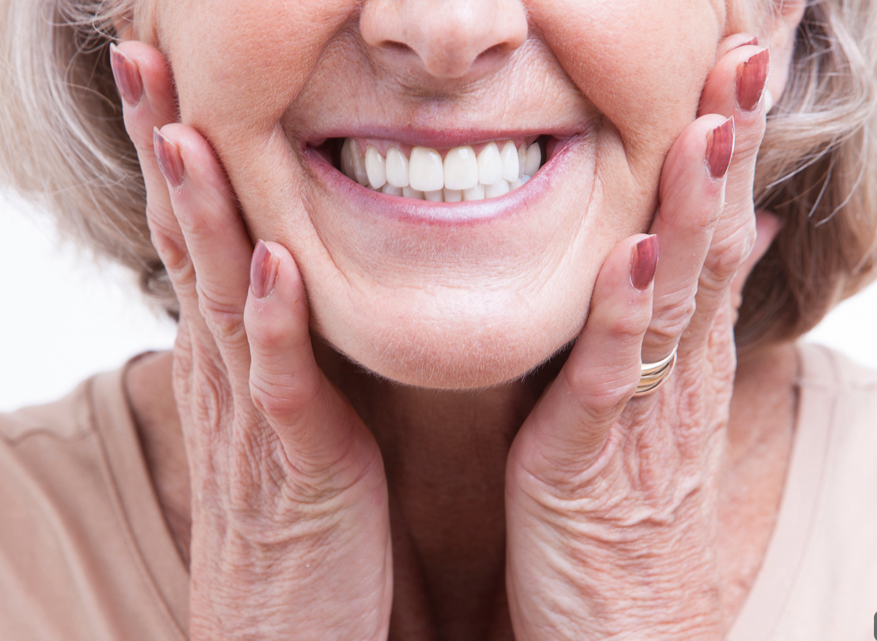 Smiling Person Gently Holding Their Cheeks With Both Hands — Smiles On Hobart in Hobart, TAS