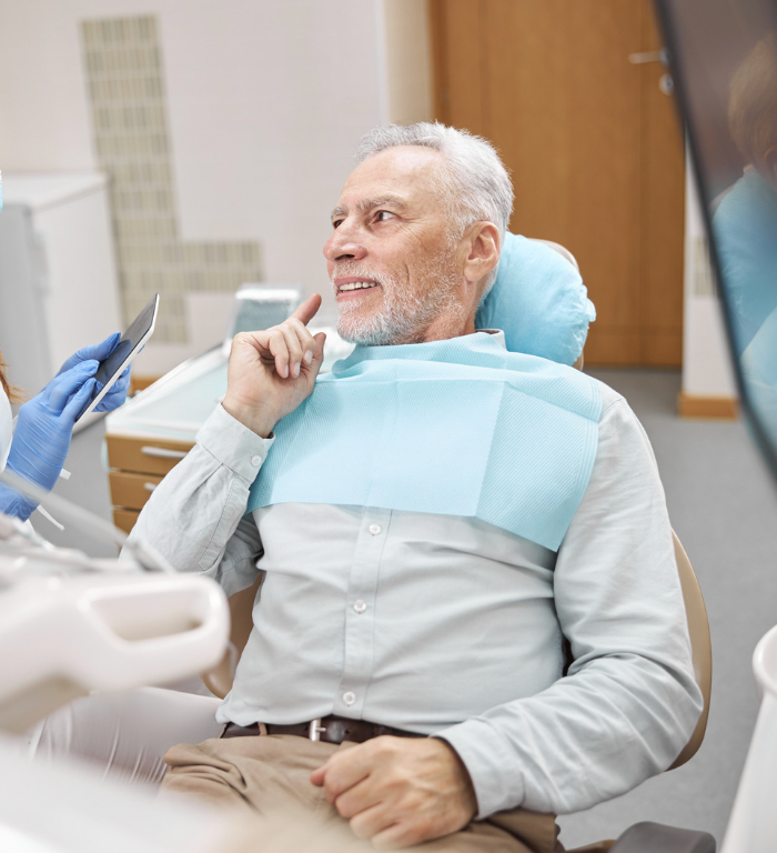 Patient in Dental Chair Smiling While Dentist Works — Smiles On Hobart in Glenorchy, TAS