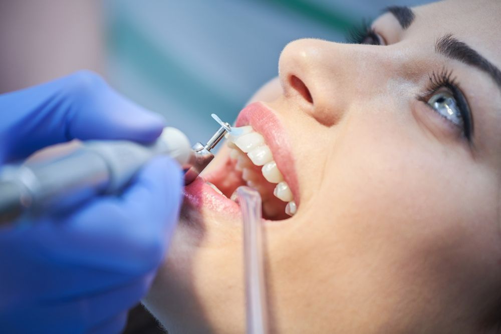Dentist Using a Tool to Clean a Patient’s Teeth During an Exam — Smiles On Hobart in Hobart, TAS