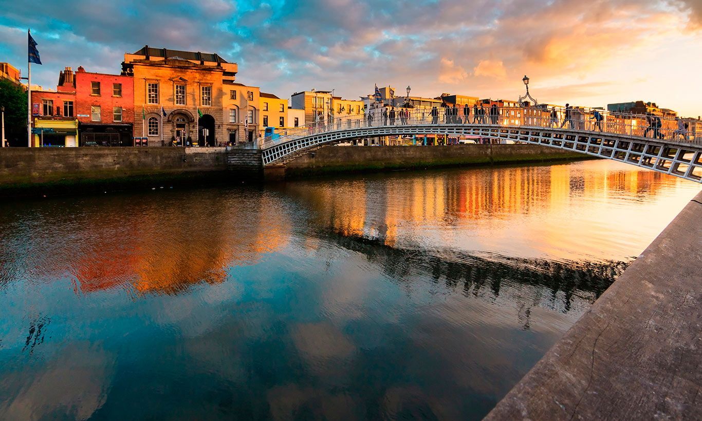 Ha’penny Bridge over the River Liffey in Dublin at sunset, reflecting the colorful sky in the water. Jean Francois Mathieu presents at the ILA International Listening Convention 2018