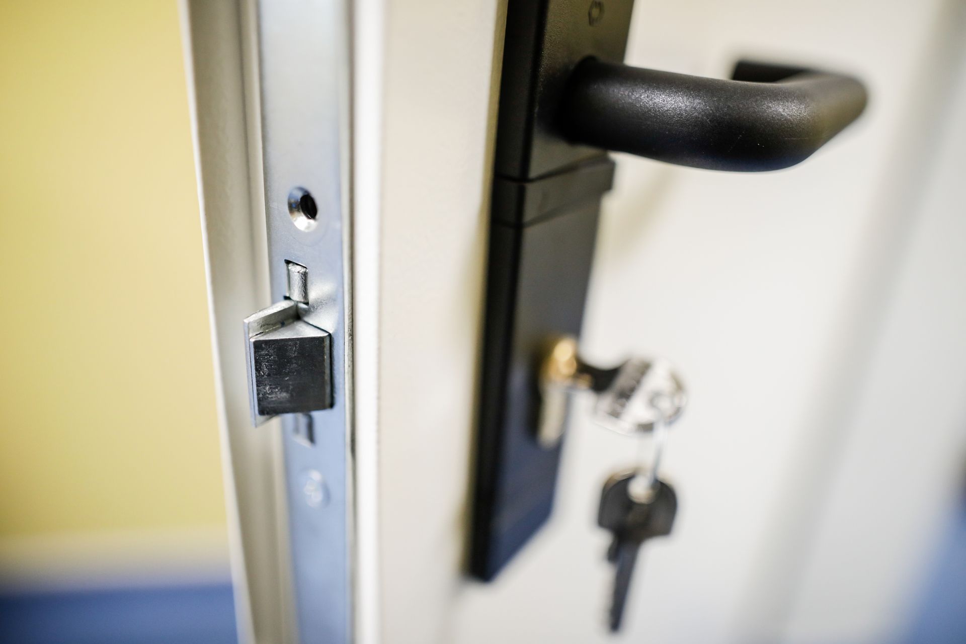 A close up of a door with a lock and keys on it.